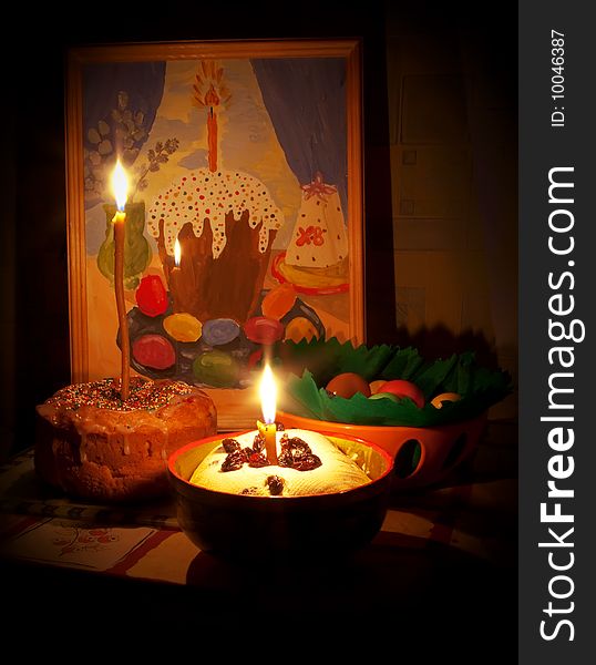 Easter cake and eggs with candles and picture