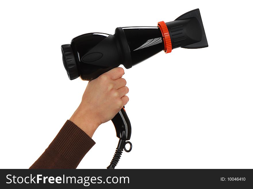 The girl holds the hand of a professional hair dryer in black with a nozzle on a light background. The girl holds the hand of a professional hair dryer in black with a nozzle on a light background
