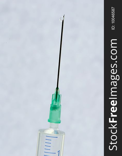 Syringe with needle ready for injection on a light background. Syringe with needle ready for injection on a light background