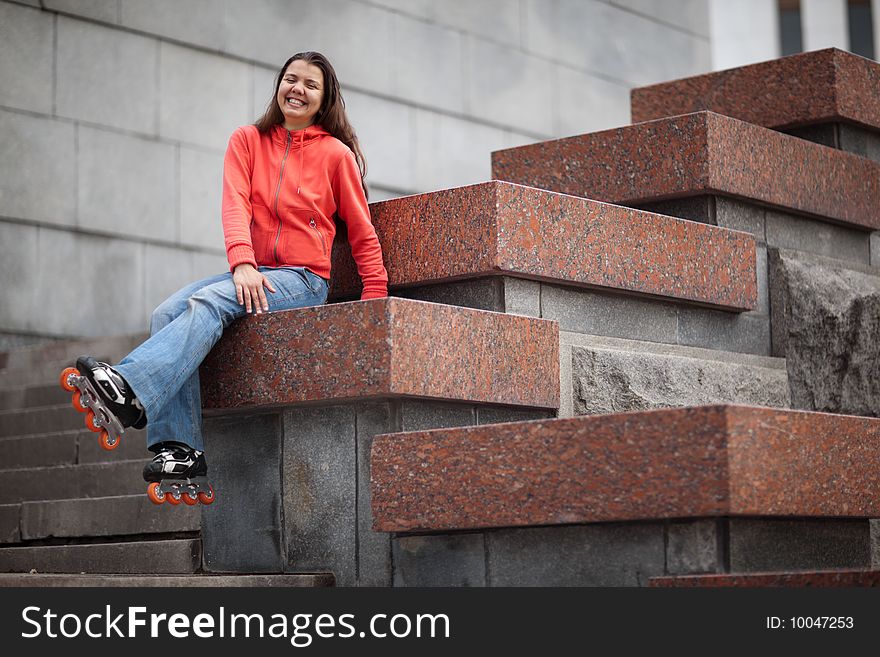 Portrait of rollerskating girl on granite stairs - shallow DOF