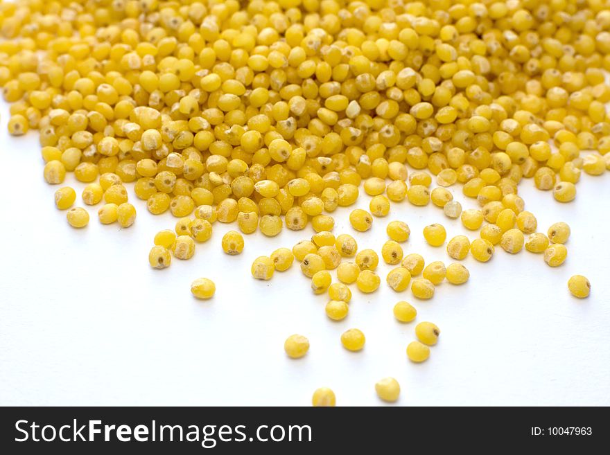 Yellow millet on white background