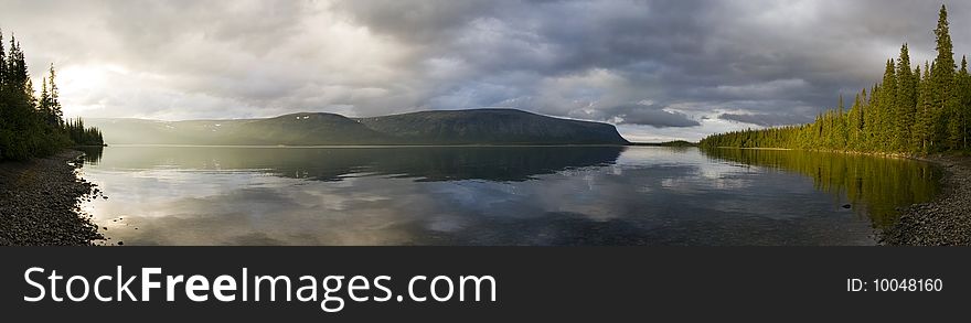 Panorama of a sunlitted foggy lake. Panorama of a sunlitted foggy lake