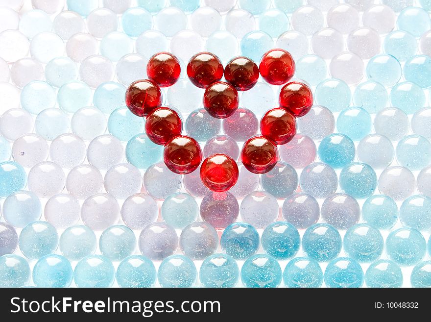 Red glass heart on blue background. Red glass heart on blue background