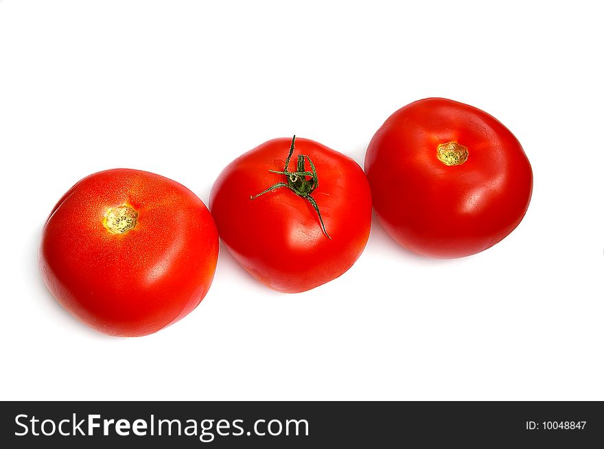 Three tomatoes in a row, on the white background