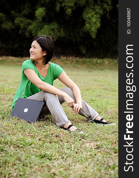 Asian Girl Relaxing In The Park