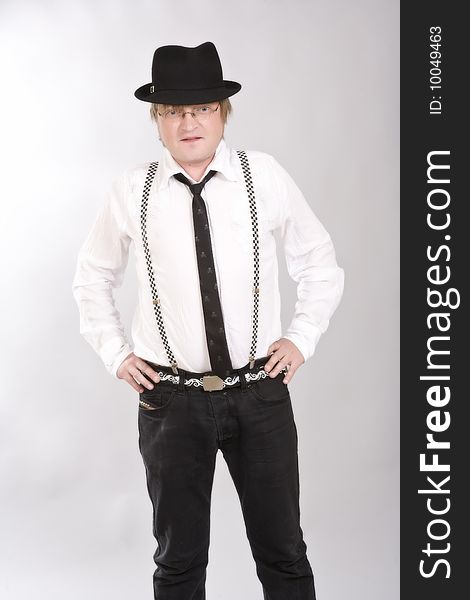 Man is in a hat, suspenders and tie of hand