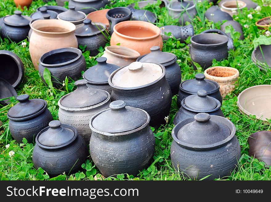 Antique clay pots on green grass