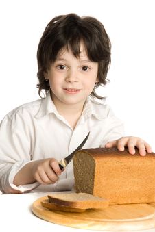 The Liitle Boy Wich Slicing A Bread On Desk Royalty Free Stock Photo The Liitle Boy Wich Slicing A Bread On Desk Royalty Free Stock Photo