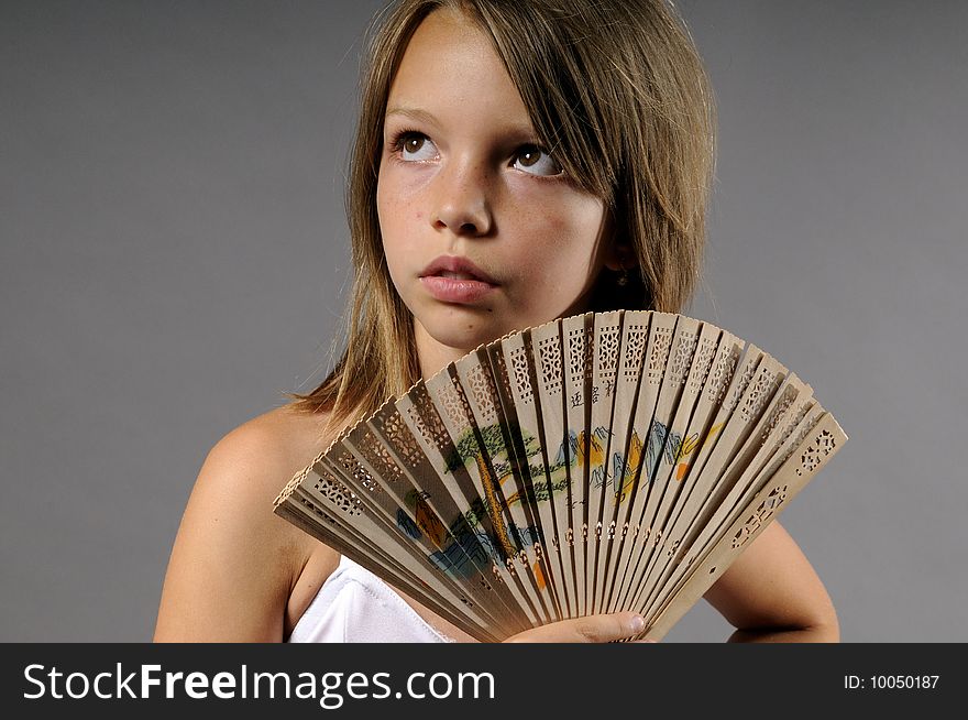 Portrait of young ballerina with colored fan. Portrait of young ballerina with colored fan