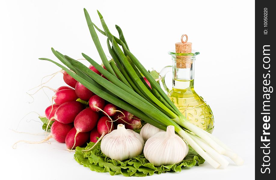 Green vegetables and a bottle of olive oil on the white background. Green vegetables and a bottle of olive oil on the white background