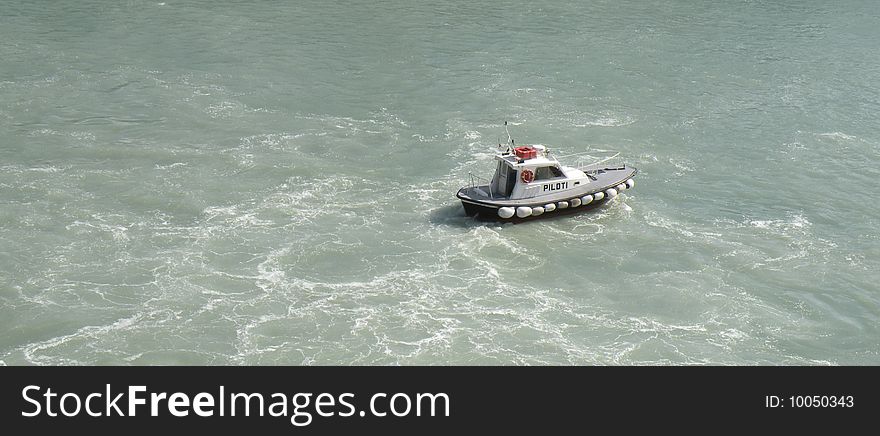 A pilot boat guiding way out of ferry in ancon port