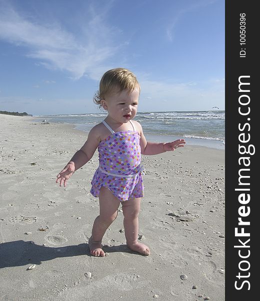 Little girl walking on beach. Little girl walking on beach