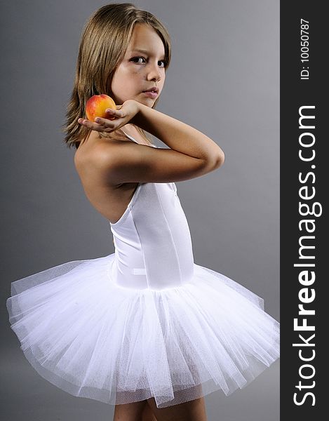 Portrait of beautiful ballerina with tasty peach. Portrait of beautiful ballerina with tasty peach