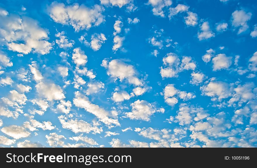 Gentle clouds in the blue sky illuminated by the sun. Gentle clouds in the blue sky illuminated by the sun