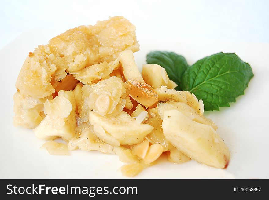 Apple pie with chopped almonds and mint