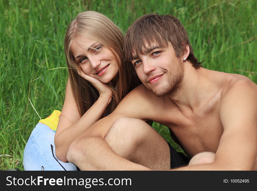 Couple of young people having a rest on a beach. Great summer holidays. Couple of young people having a rest on a beach. Great summer holidays.