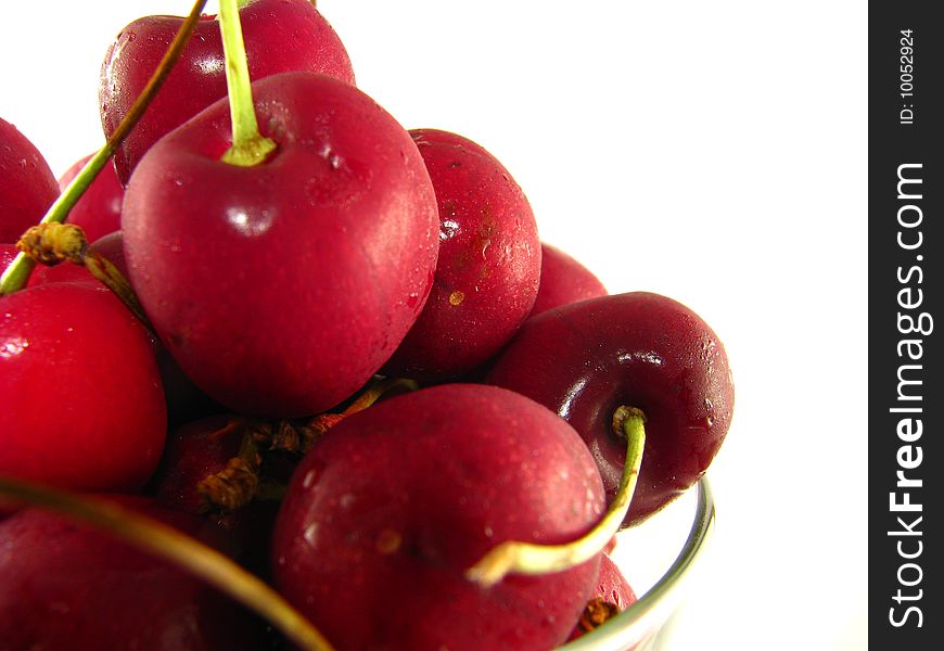Close-up of a bowl of fresh cherries on a white background. Close-up of a bowl of fresh cherries on a white background