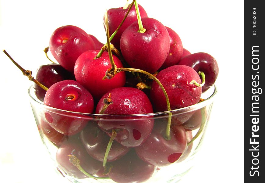 A bowl of fresh cherries on a white background. A bowl of fresh cherries on a white background