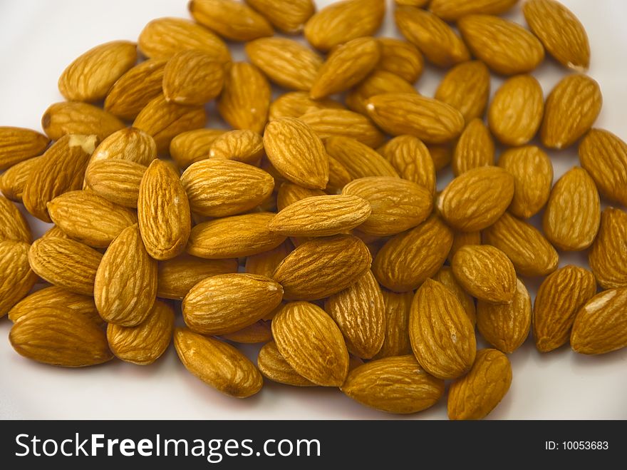 A pile of almonds isolated on white. A pile of almonds isolated on white