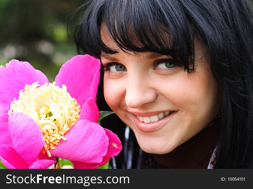 Portrait of the young nice girl with a flower. Portrait of the young nice girl with a flower