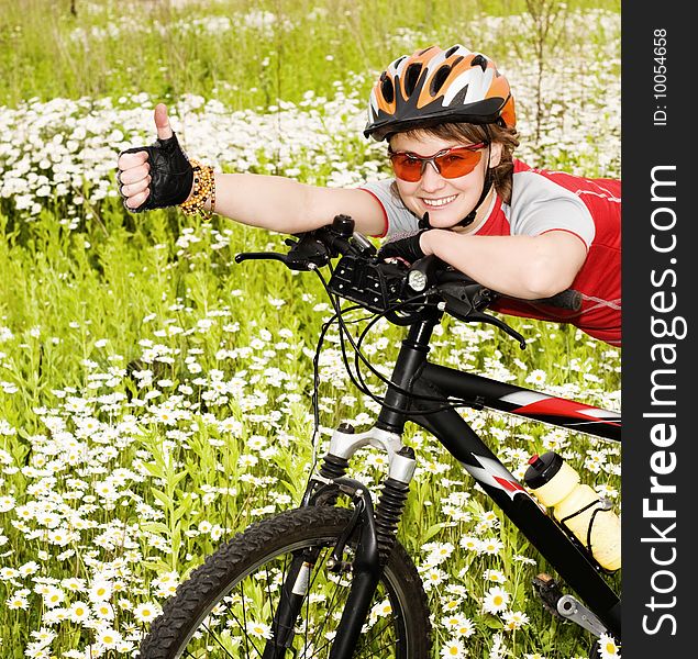 An image of a girl with a bicycle in the field. An image of a girl with a bicycle in the field