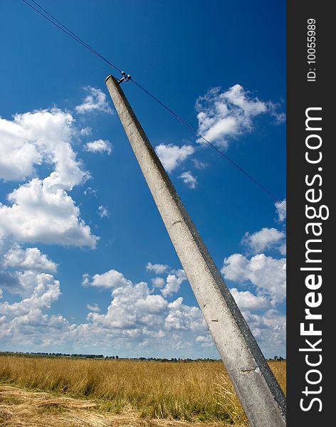 Inclined post with electric cable at hay valley & cloudy blue sky