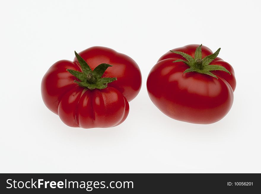 Two biologically cultivated tomatoes, small size with hand made clipping path. Two biologically cultivated tomatoes, small size with hand made clipping path