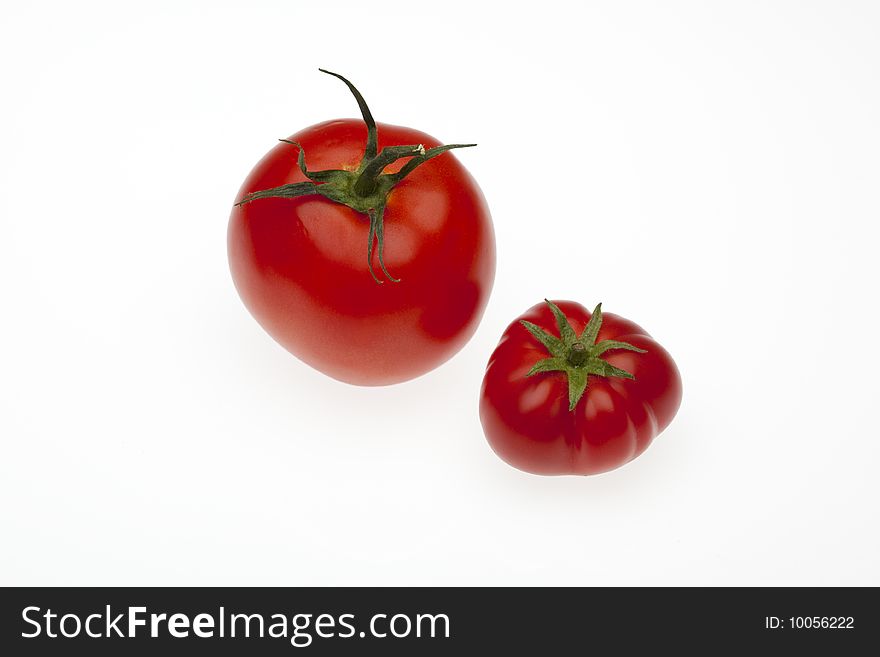 Two tomatoes one from biological culture and one from regular trade. Two tomatoes one from biological culture and one from regular trade