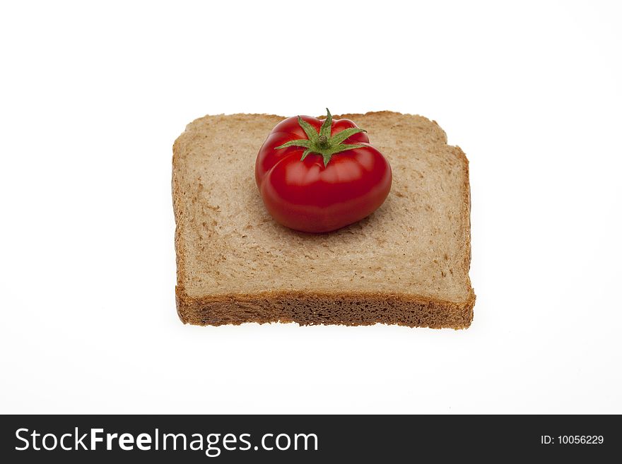 A small tomato on a slice bread for toasty of total milling. A small tomato on a slice bread for toasty of total milling