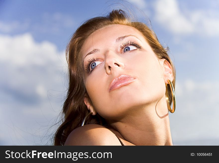 Expressive portrait of a woman on the sky background. Expressive portrait of a woman on the sky background