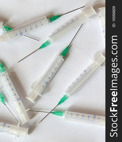 Syringes randomly scattered on a white background. Syringes randomly scattered on a white background