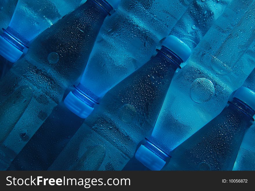 Chill water in small bottles on blue background