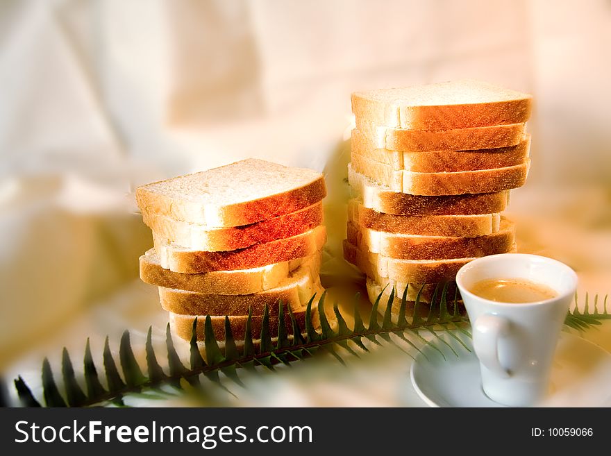 Coffe and bread in a white background