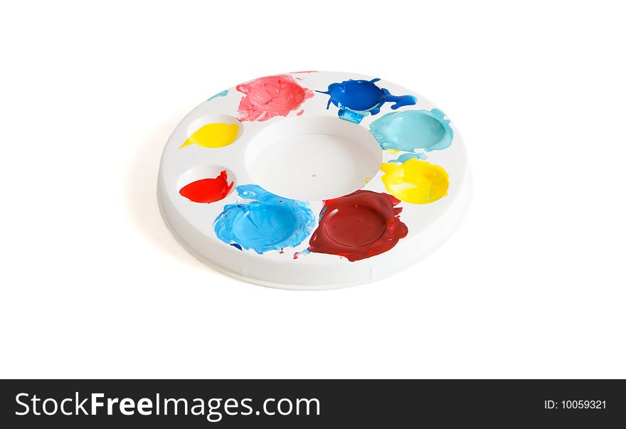 Round kids' palette with colorful paints isolated. Round kids' palette with colorful paints isolated