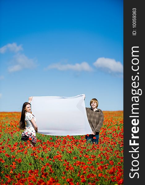 Lovely couple in the poppy field, copy-space for your text