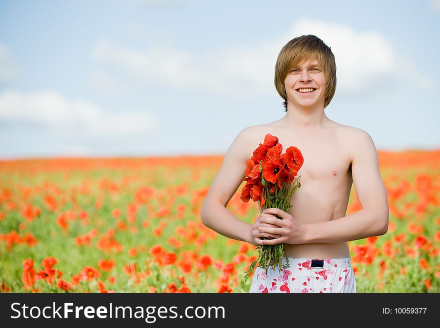 Smiling man with bouquet of poppies. Smiling man with bouquet of poppies