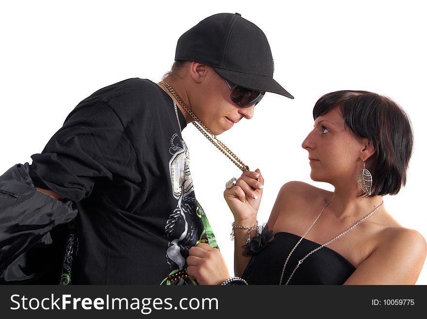 Young couple in love is about to kiss. The woman is pulling the man closer with his necklace. Isolated over white. Young couple in love is about to kiss. The woman is pulling the man closer with his necklace. Isolated over white.