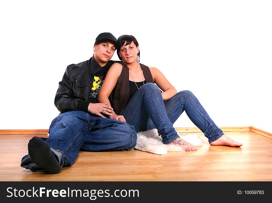 Young stylish couple sitting on the floor of their new home!. Young stylish couple sitting on the floor of their new home!