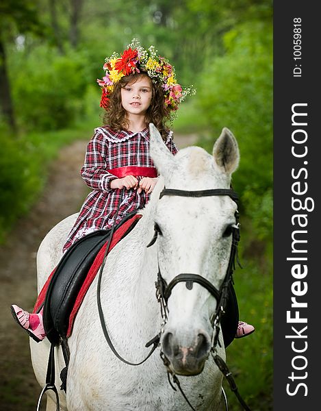 Cute little girl in floral wreath