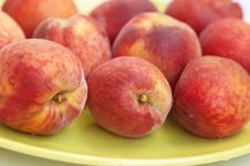 Riped Peaches On Green Plate Stock Images
