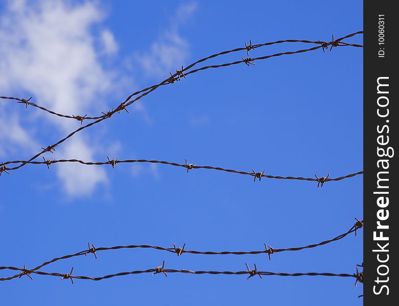 Baber wire against blue sky. Baber wire against blue sky