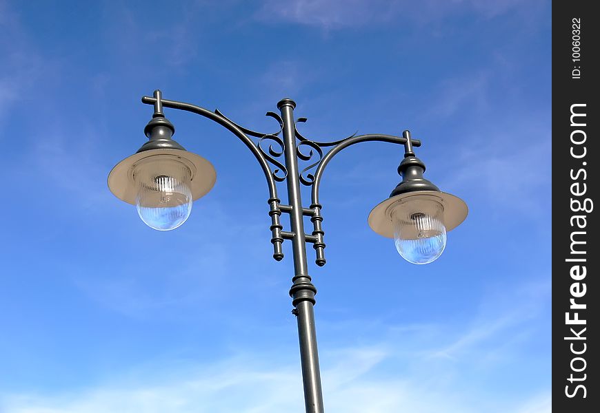 Closeup of the retro lamppost on the beauty blue sky.