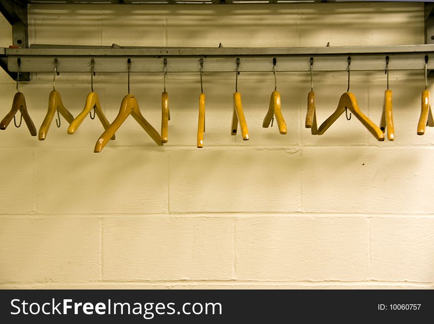 A set of woorden hangers in an unused area of a public building. A set of woorden hangers in an unused area of a public building.