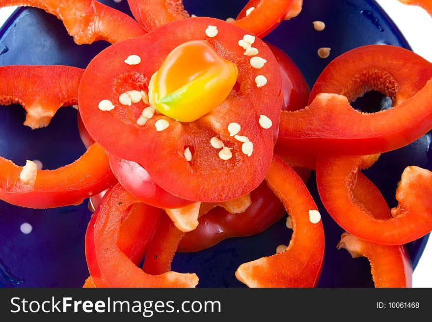 Sliced fresh red pepper on blue dish. Sliced fresh red pepper on blue dish