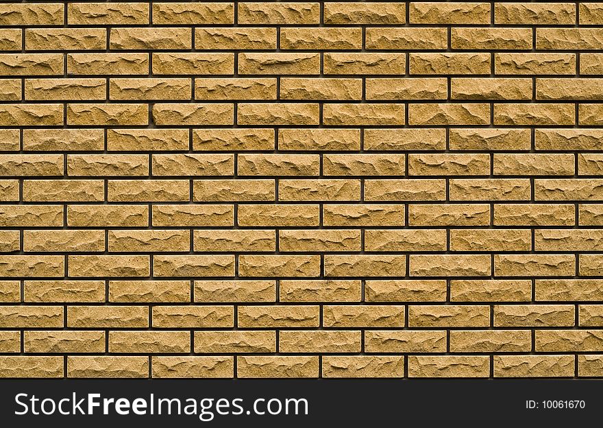 Even yellow, rough brick wall in not houses