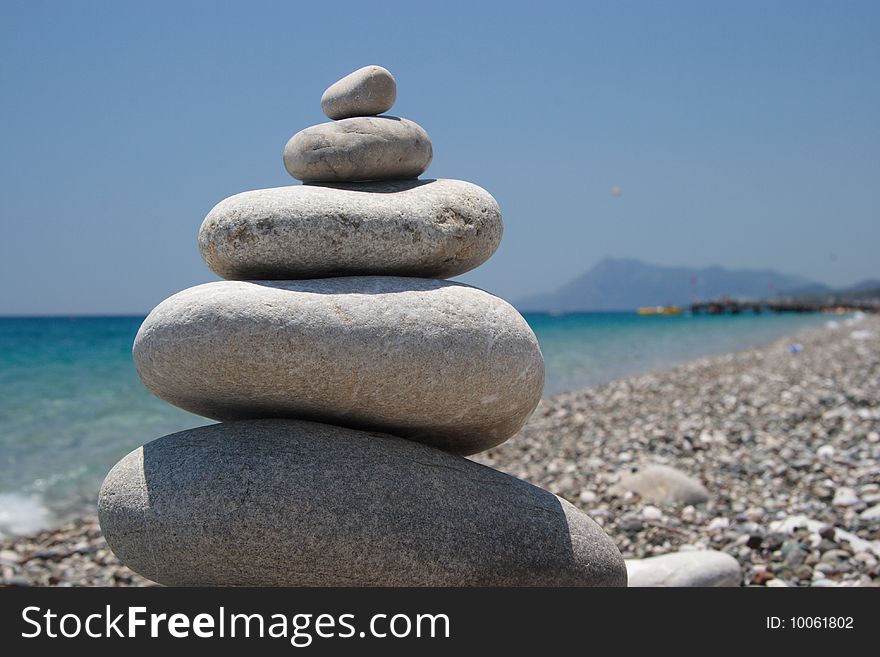 Stones on the seashore, pyramid on the beach