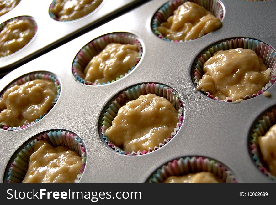 Cupcake batter in a baking pan.