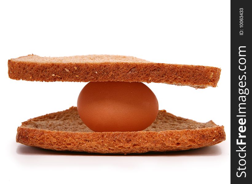 Taken in studio of an egg between two pieces of bread. Taken in studio of an egg between two pieces of bread