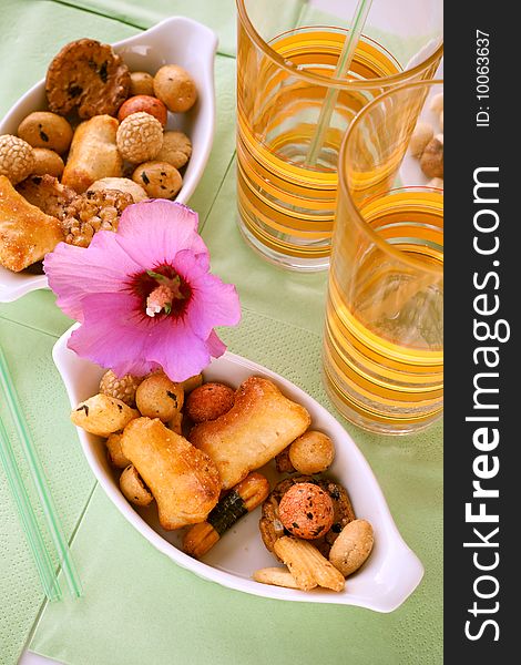 Rice snacks served with a flower and two long-drink glasses on the table. Rice snacks served with a flower and two long-drink glasses on the table