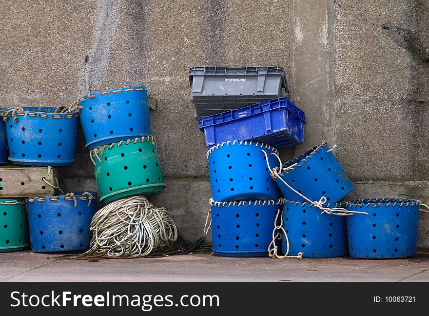 Blue and green plastic fish-containers